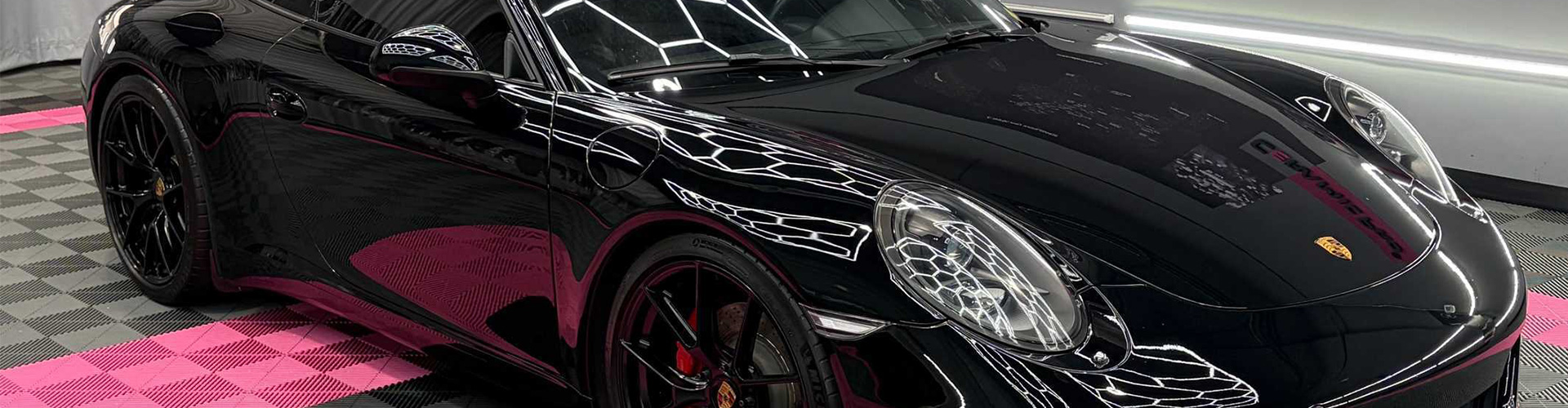 A car with chrome accents is being polished at Apex Auto Works.